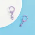 Close-up detail shot of purple baking paint zinc alloy D-ring keychain DIY craft accessory. - Purple