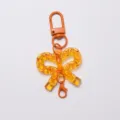 Portachiavi fiocco in acrilico trasparente arancione con moschettone per elegante borsa. - Fibbia a Fiocco / Arancione