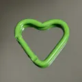 Close-up detail of green heart-shaped aluminum alloy carabiner snap hook, smooth finish. - Heart Buckle / Green