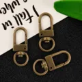 Metal swivel snap hooks for DIY keychains, bronze hardware clips with round rings accessories. - Bronze