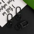 Detail view of black zinc alloy swivel snap hooks, 32mm universal keychain clasp hardware. - Black