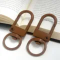 Detailed view of brown metal gate buckles, swivel keychain clips for DIY bag accessories. - Coffee Gate Buckle