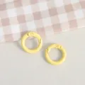 Yellow metal spring O-rings, close-up view of DIY handmade jewelry accessories and key ring findings - Light Yellow