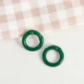 Close-up detail of green round spring rings, zinc alloy for DIY handmade accessories. - Dark Green