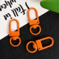 Orange metal swivel snap hooks for DIY jewelry making, bag charms, and keychain hardware accessories. - Orange