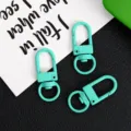 Detail view of three green zinc alloy swivel snap hooks, keychain diy accessories. - Mint Green