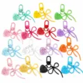 Alloy hollow bow keychain with colored heart tag, stylish bag charm and DIY pendant accessory. - Multicolor