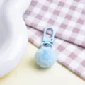 Close-up detail of a cute light blue fluffy pom pom keychain with matching clasp. - Plush Ball + Clasp / Blue