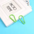 Primo piano di un moschettone portachiavi in alluminio verde brillante per accessori fai da te. - Verde Erba