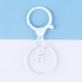 White metal lobster clasp keychain accessory detail, durable painted metal hardware for DIY crafts. - White Painted Round Dragon Buckle 3-Piece Set