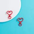 Gros plan de mousquetons rouges en forme de cœur en alliage pour bijoux DIY et loisirs créatifs. - Rouge Vif