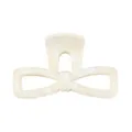 Close-up detail of the elegant marble bow hair claw, featuring chic acrylic design for daily styling. - Beige