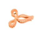Close-up detail of the peach orange bow hair claw clip, showing hollow texture and finish. - 11x6.5x5cm / Orange