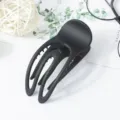 Minimalist matte black hair claw clip, hollow concave design for secure and stylish updos. - Black