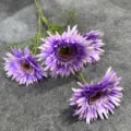 Detailed view of 4-head purple artificial gerbera daisy flowers with green leaves for wedding. - Purple