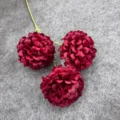 Detail view of 3-head artificial chrysanthemum flower featuring dark red ball blooms and green stems. - Red