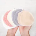 Detailed view of reusable cotton gauze nursing pads, soft washable breast pads for mothers. - White
