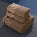 Premium cotton towel set in rich brown with elegant embroidered geometric border pattern. - 35*70cm / Grid Brown