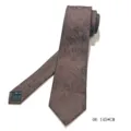 Brown leaf pattern tie detail showcasing premium fabric texture and neat handmade tailoring. - Dark Branch Style