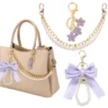Gedetailleerd overzicht van parelketting en paarse strik tasbedel, elegante handtasaccessoire. - Stijl 6