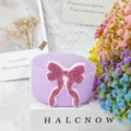 Silicone cup sleeve detailed view, featuring sparkling pink bowknot decor in purple finish. - Purple