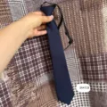 Navy blue polyester pre-tied necktie for kids, solid color school uniform tie detail view. - No. 03 Pre-Tied Necktie / 38x7cm / Navy Blue