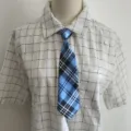Classic blue and black plaid short tie with matching grid shirt for stylish student outfits. - Sky Blue