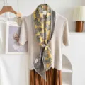 Close-up detail of luxury silk wool blend paisley neckerchief scarf in yellow and grey. - Yellow Purple Paisley