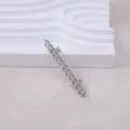 Silver chain brooch detail shot, stylish metal lapel pin accessory for suit and coat. - Silver