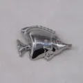 Detailed view of silver tropical fish brooch, vintage ocean animal lapel pin accessory. - Silver