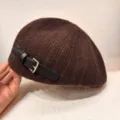 Close-up detail of brown knitted beret, featuring side PU leather strap and metal buckle. - Dark Brown