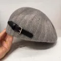 Detailed view of grey knit beret with black leather strap buckle for women chic style - Gray