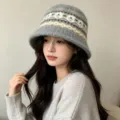 Detail view of the stylish women's autumn winter knitted bucket hat with fair isle pattern. - One Size / Gray Jacquard