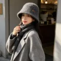 Detail view of a stylish knitted bucket hat for women, featuring a rolled edge and warm winter design. - One Size / Gray With Handmade Label