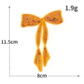 Toppa ricamata con fiocco in paillettes dorate per decorare vestiti, scarpe e borse. - Fiocco Arancione (M1643)
