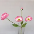 Detailed view of pink artificial poppy flower branch in a clear glass vase for decor. - Pink