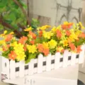 Artificial flower set in white wooden fence pot, perfect for home desktop and wedding decor. - Small Floral Sunset Red