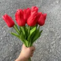 Artificial red PU tulips bouquet with realistic touch and leaves, perfect for home decor. - Bright Red