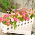 Artificial pink flowers in a white wooden fence pot for home desktop decoration - Small Floral Hot Pink