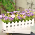 Artificial flowers in white picket fence planter, purple and yellow silk wildflowers. - Small Floral Purple Orchid