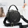 Black PU leather round crossbody bag for women, stylish printed shoulder bag with wide strap. - Black