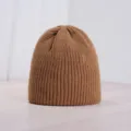 Solid color knitted beanie for winter, warm ribbed winter hat in brown style detail view - One Size / Caramel color