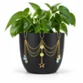 Gold plant pot hanging ornament with iridescent crystals and star pendant, garden decor detail. - Pentagram Style