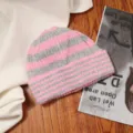 Nahaufnahme der rosa-grau gestreiften Strickmütze Textur, weich und warm für den Winter. - Einheitsgröße / Dunkelrosa Gestreift
