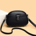 Bolso cruzado de cuero negro clásico para mujer, elegante bolso redondo con detalle trenzado. - Negro