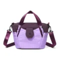 Stylish purple nylon shoulder bag with top handles and adjustable strap for women commuting. - Purple
