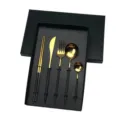 Detailed view of the 5-piece black and gold stainless steel cutlery set inside gift box. - Black & Gold