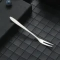 Stainless steel two-tine fruit fork, ideal for desserts, cakes, and home dining use. - 304 Silver