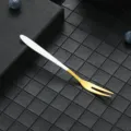 Stainless steel fruit fork with white handle and gold finish, perfect for desserts and cakes. - 304 White Gold