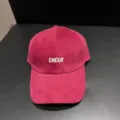 Red suede baseball cap detail view showing white embroidered letter design on front. - Adjustable / Burgundy